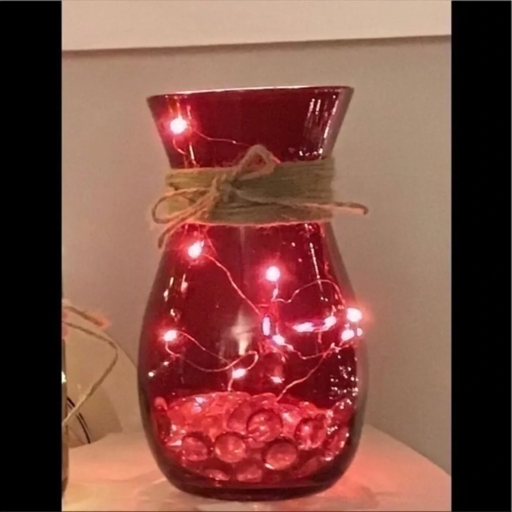 Red vase with string fairy lights
